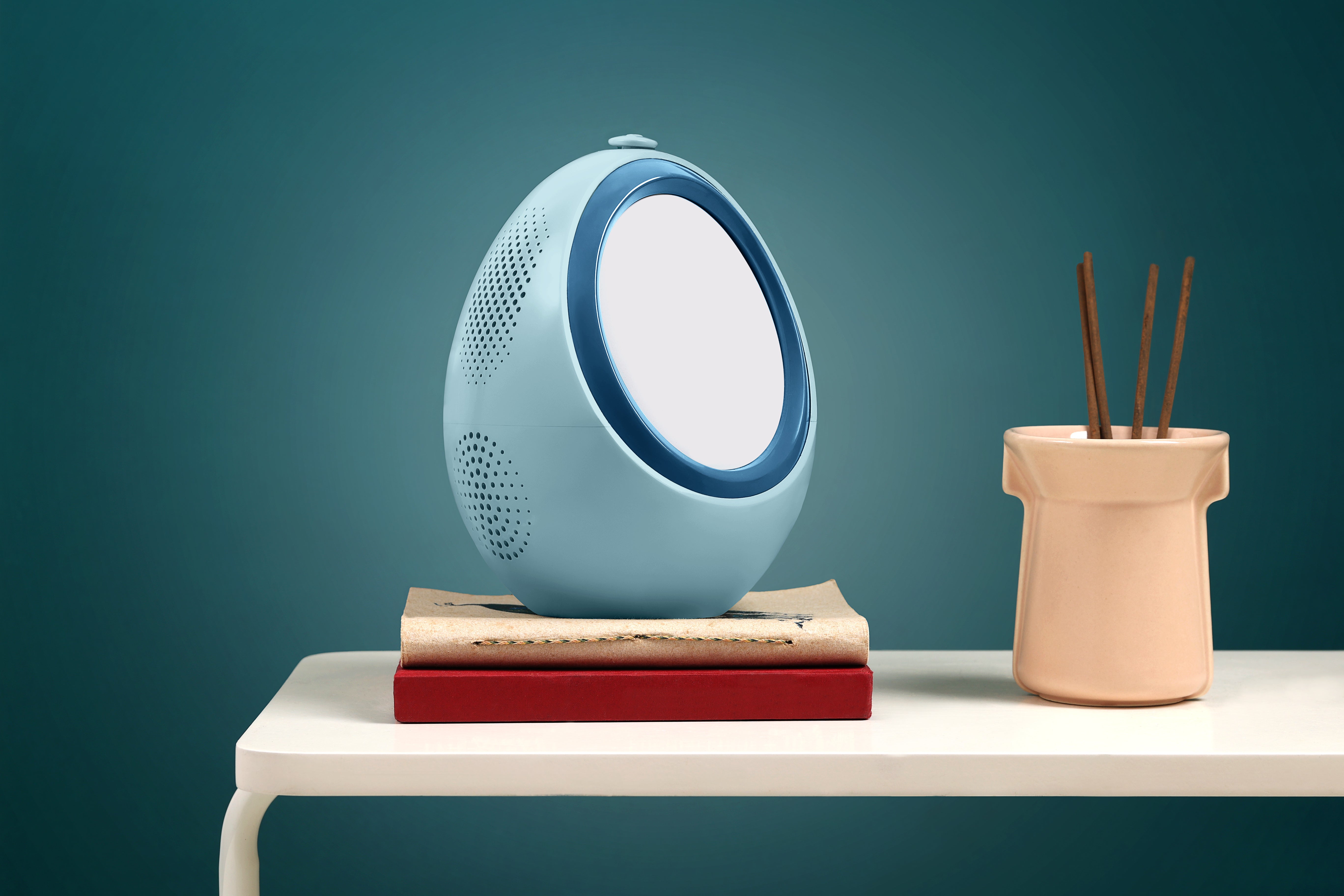 blue AI sleep device by Naptick with light and sound features placed on table
